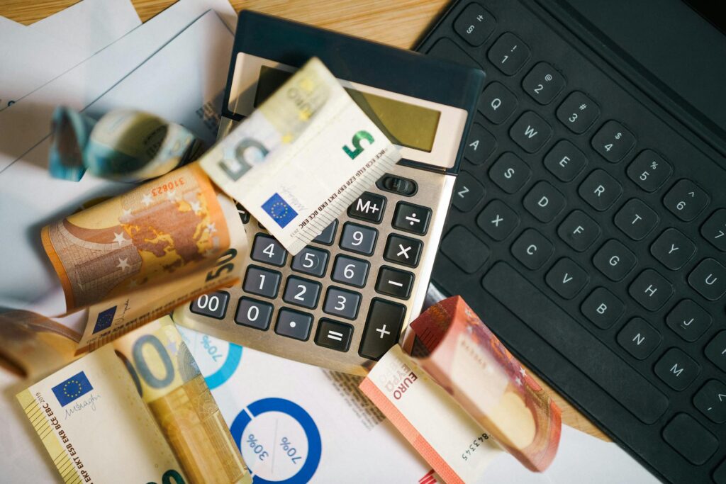 euro banknotes with calculator and laptop keyboard